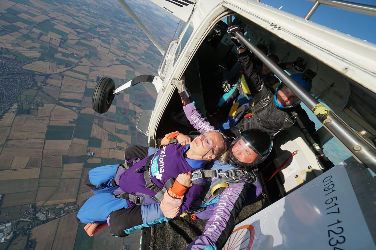 sky diver in lymphoma action tshirt about to jump from plane