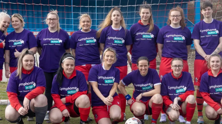 Girls football team standing together wearing Lymphoma Action t-shirts 