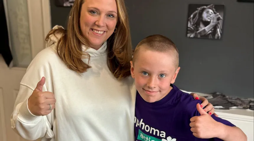Lady and Son wearing a Lymphoma Action T-shirt after doing his head shave 